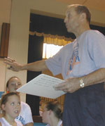 Hugh Roberts instructs a group of young basketball players. Roberts is the founder of Boys and Girls Club Basketball in Randolph. Photo by Jesse Raymond.