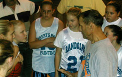 Roberts talks with the girls' 7th grade basketball team.  Photo by Jesse Raymond.
