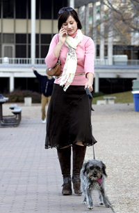 going mobile: Carina Spaulding does a bit of multitasking while walking her dog, Nina, along Madison's lakeshore.