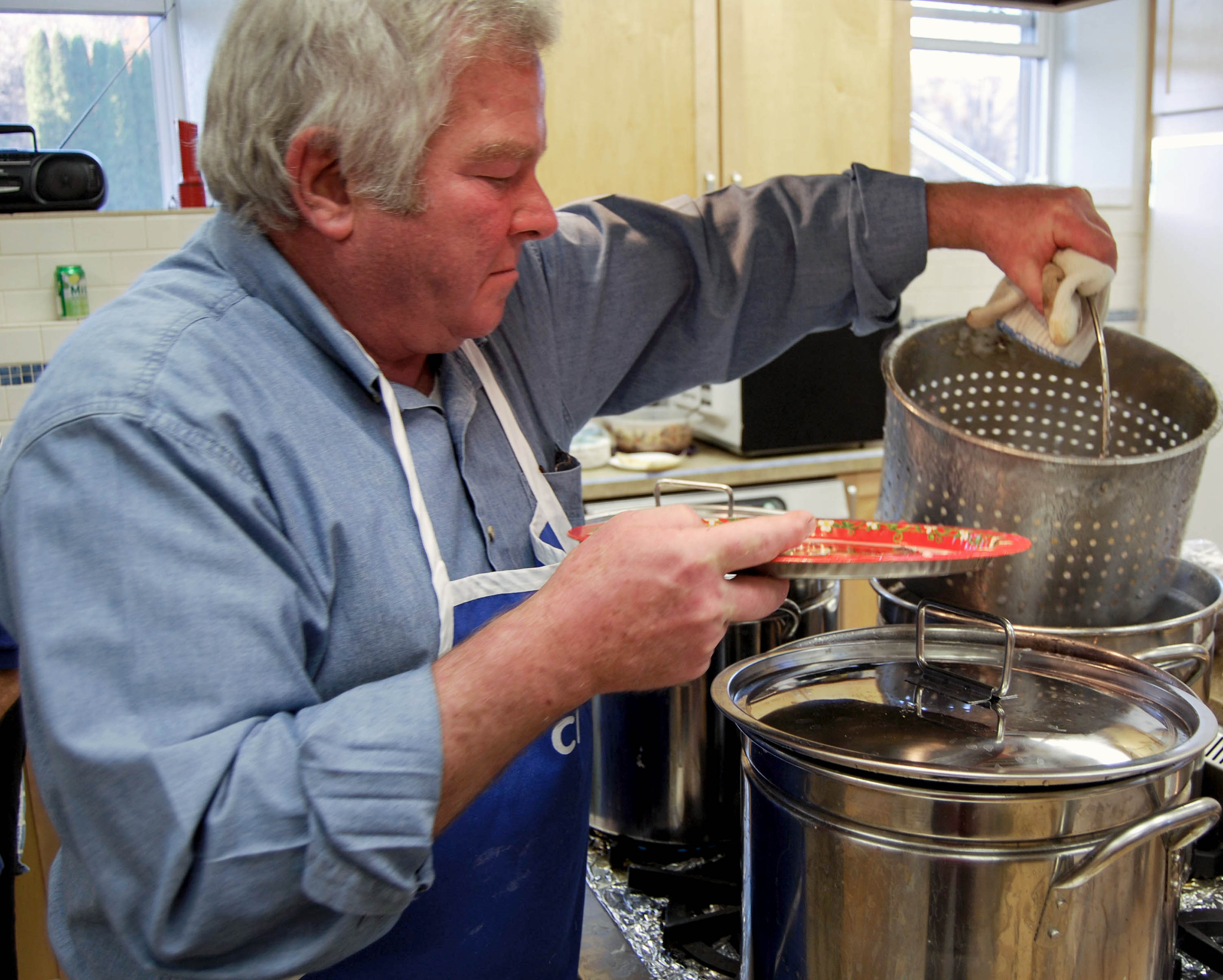 After simmering in water, Greg Herrling prepares to put lutefisk on a plate.
Photo by: Molly Reppen