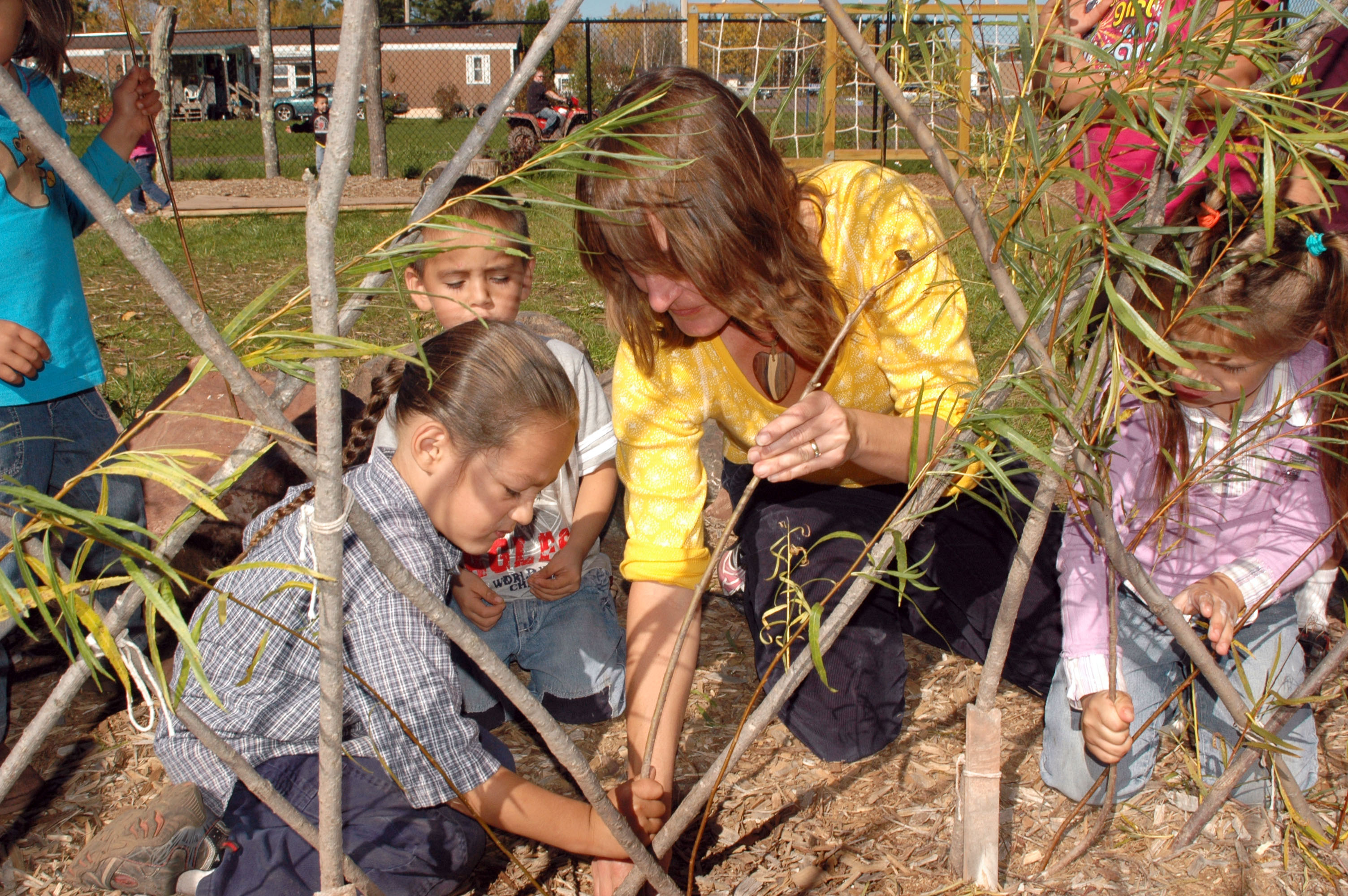 The Bad River Indian Reservation involves children in planting and creating a willow lodge. Menominee Nation has taken similar steps in involving children in similar healthy community efforts. 
Photo by: