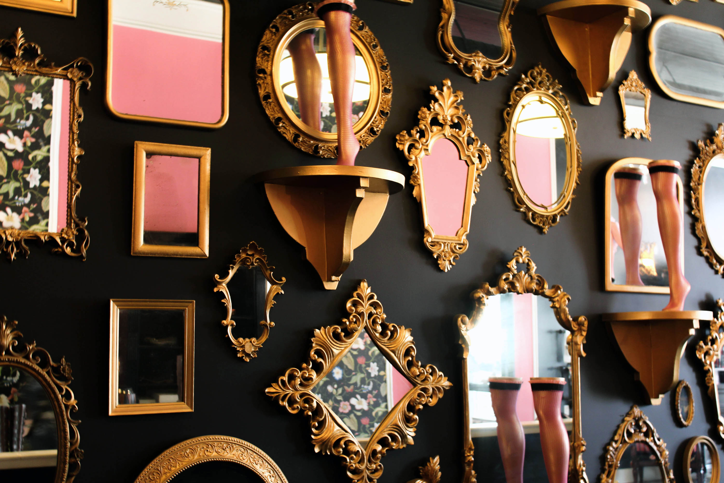 A wall of gold-painted mirrors adds character and creative flair to Kick's design.