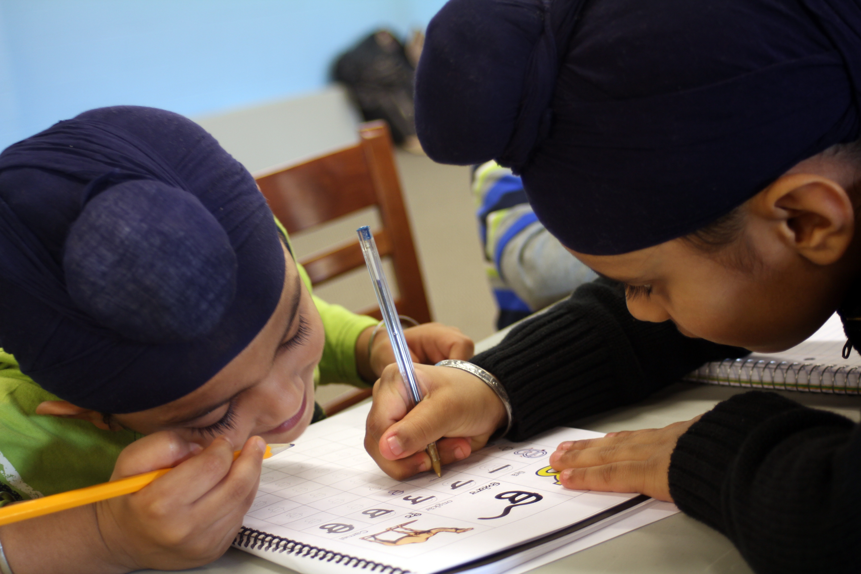 Downstairs in the basement, children work with their peers and teachers in Punjabi classes. The kids learn to read, write and speak the language.
Photo by: Aimee Katz