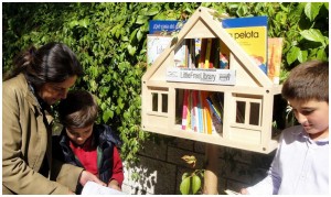 family taking books from little free library
