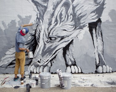 Artist Alexander Landerman works on the mural on the west-facing wall of Divepoint Scuba in downtown Stevens Point, Wednesday, Sept. 16, 2015.