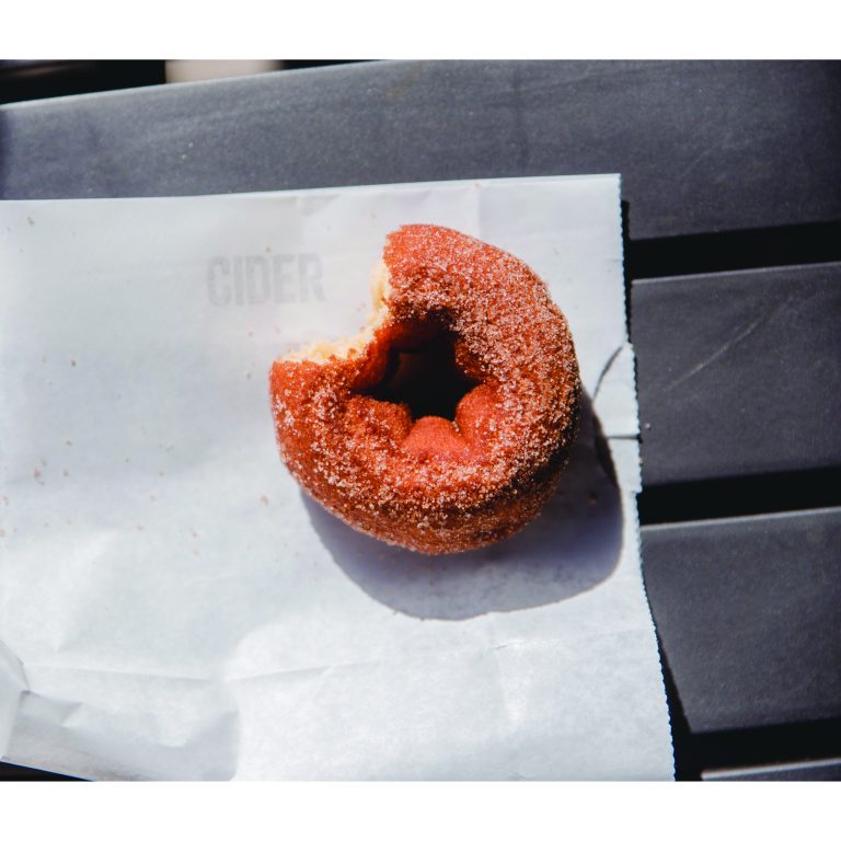 An apple cider donut basks in the setting October sun.