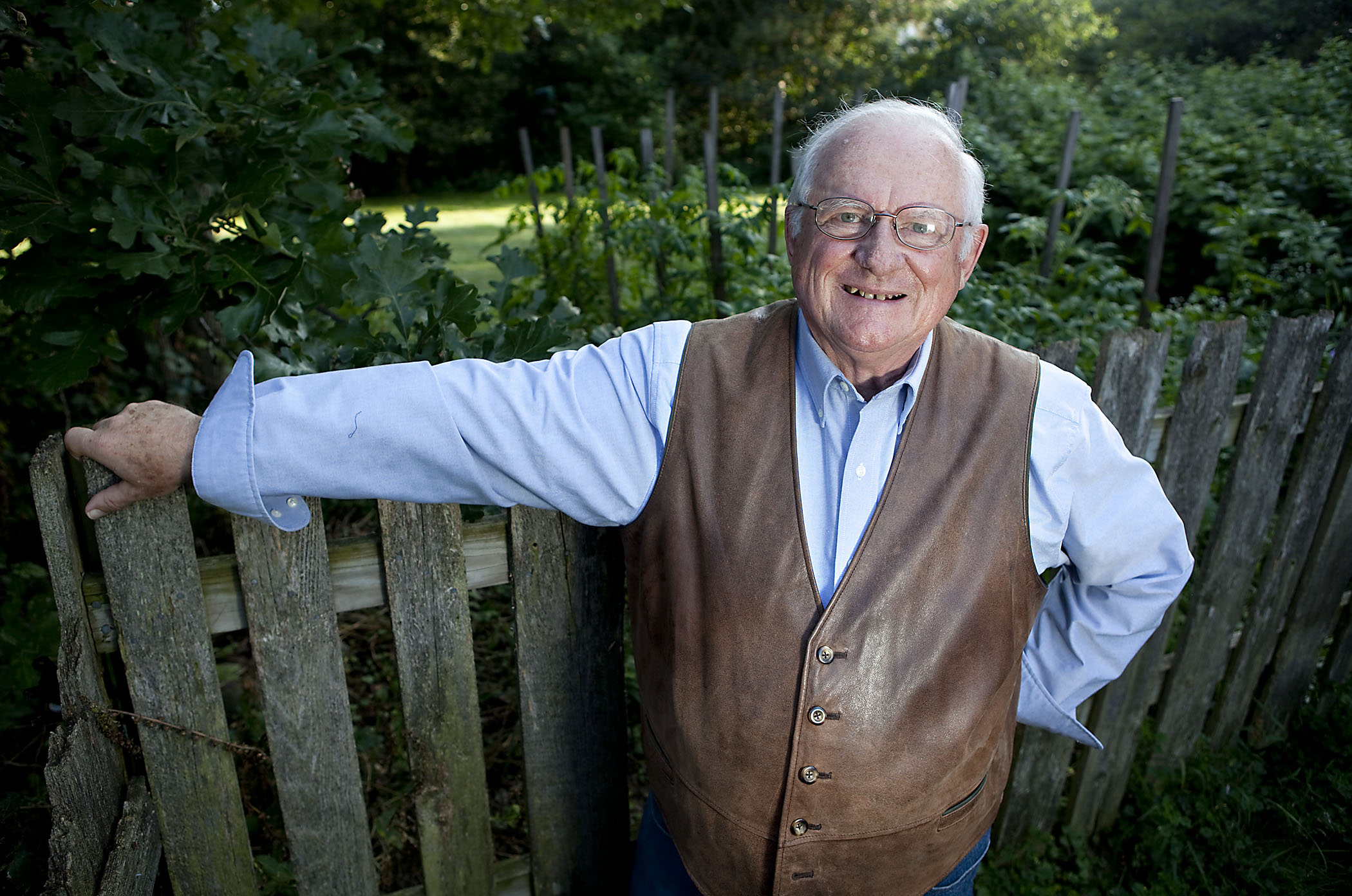 Author Jerry Apps stands in front of a garden