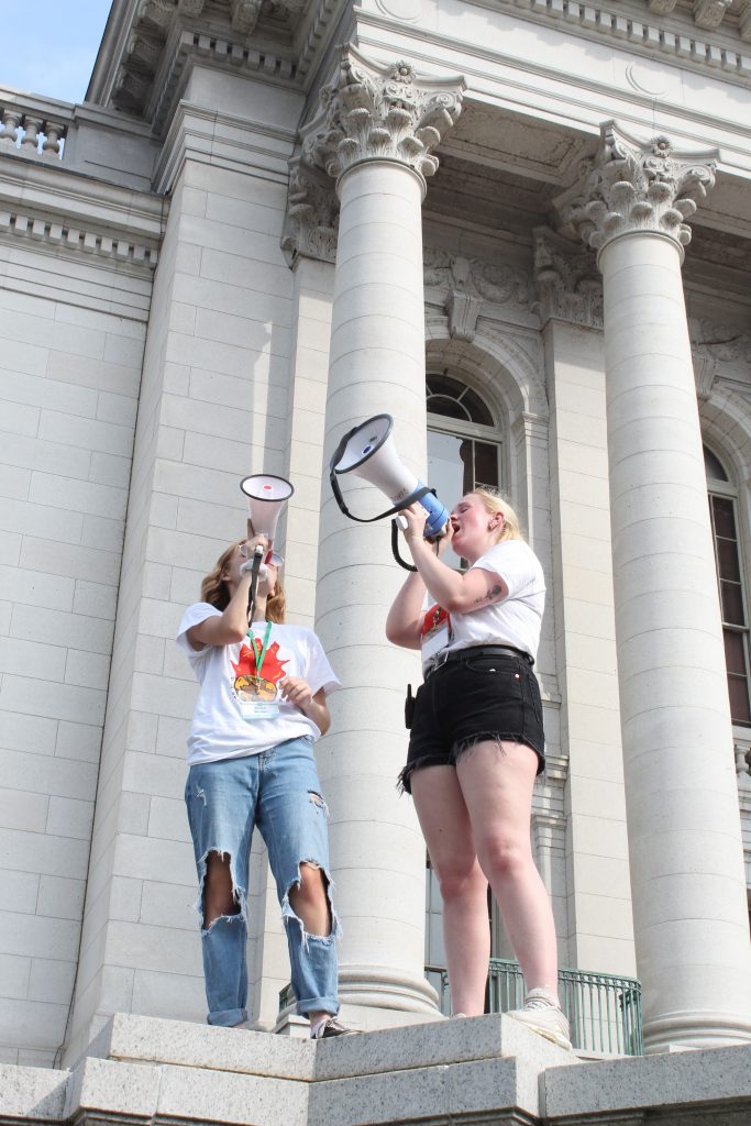 Two girls on megaphones protesting climate change