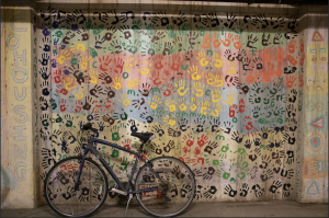 Bike in garage against handprint mural